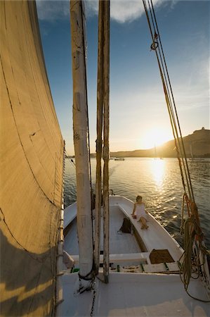 egyptian sailing on nile river - Woman relaxing on deck of felucca at dusk Stock Photo - Rights-Managed, Code: 832-03724575