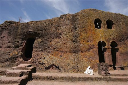 Priest sitting outside rock church Stock Photo - Rights-Managed, Code: 832-03724677