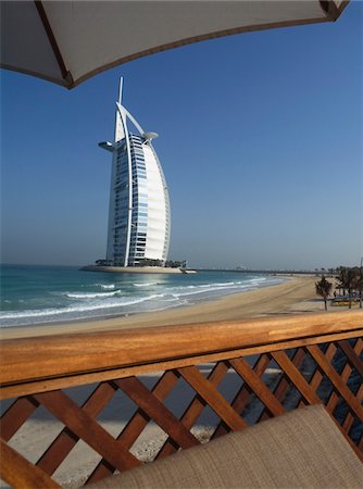 dubai beaches - Modern building by sea viewed from under umbrella Stock Photo - Rights-Managed, Code: 832-03724893