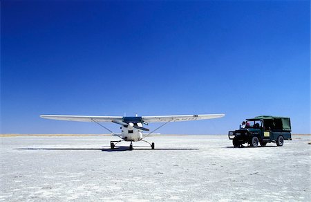 Plane and safari vehicle on salt pans Stock Photo - Rights-Managed, Code: 832-03723634