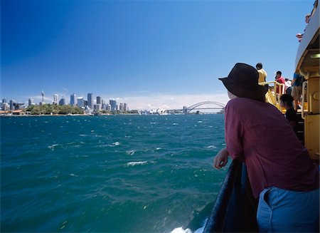 simsearch:862-03288987,k - Woman leaning on railing on a ferry passing Sydney city centre Stock Photo - Rights-Managed, Code: 832-03723881