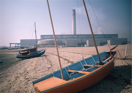 family in boat by beach - Fawley Power Station, Hampshire. Architects: Farmer and Dark Stock Photo - Rights-Managed, Code: 845-04826425