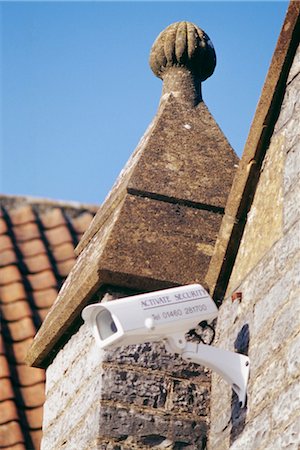 simsearch:845-03463486,k - CCTV security camera mounted on top of old stone building in market square of small country town. Somerton, Somerset. Stock Photo - Rights-Managed, Code: 845-04827098