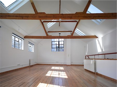 Empty Office Space With Exposed Timber Beams And Velux