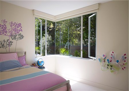 Bedroom with corner windows . walls decorated with butterlies and painted flowers. Architects: Dumican Mosey Architects Stock Photo - Rights-Managed, Code: 845-05838195