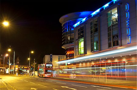 View of the Rotunda Shopping Centre, Kingston, Surrey, at night with double-decker bus passing leaving light-trails. Stock Photo - Rights-Managed, Code: 845-05838332
