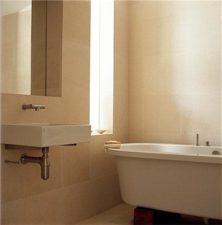 free standing bathtub - Wall mounted washbasin next to freestanding bathtub in modern bathroom. Designed by Designed by Gustavo Hernandez Stock Photo - Rights-Managed, Code: 845-05838868