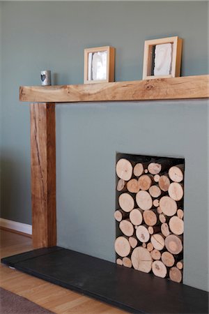 Modern fireplace with logs stored in recess Stock Photo - Rights-Managed, Code: 845-05838862