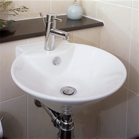 Circular washbasin, with chrome fittings, built in to tiled wall. Stock Photo - Rights-Managed, Code: 845-05838879