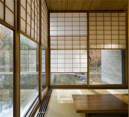 Japanese style sparsely furnished room with sliding screens at the windows Stock Photo - Rights-Managed, Code: 845-05838926