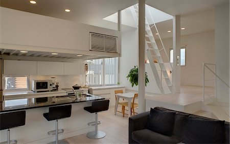 Bar stools at breakfast bar in contemporary open plan kitchen Stock Photo - Rights-Managed, Code: 845-05838928