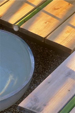 Close up of Japanese style water feature with bamboo pipe set in decking Stock Photo - Rights-Managed, Code: 845-05838932