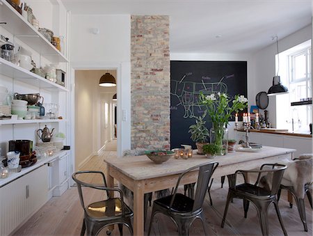 Open plan kitchen with wall shelving and window seat. Stock Photo - Rights-Managed, Code: 845-07561471