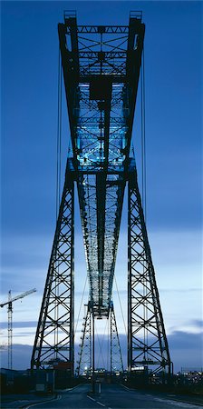 steel industry at night - Middlesbrough Transporter Bridge, River Tees, England, 1911. Bridge at dusk. Grade II star listed in 1985. Architect: Cleveland Bridge and Engineering of Darlington Stock Photo - Rights-Managed, Code: 845-02724822