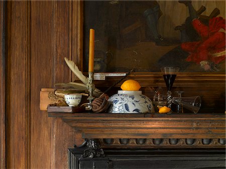 Dennis Severs House, Spitalfields, London. detail of wooden fireplace and panelling with still life arrangement of candlestick, glasses and oranges Stock Photo - Rights-Managed, Code: 845-03720357