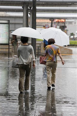 rainy street scene - Pedestrians walking in heavy rain outside Kyoto Station in Kyoto, Japan. Architects: Hiroshi Hara Stock Photo - Rights-Managed, Code: 845-03721033