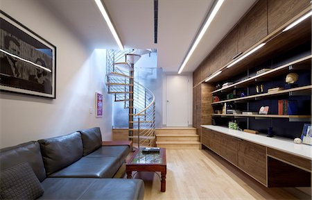 simsearch:845-02726227,k - Modern open-plan living room with spiral staircase, sofa and storage unit and desk. Architects: WE Design - Winston Ely Foto de stock - Con derechos protegidos, Código: 845-03721258