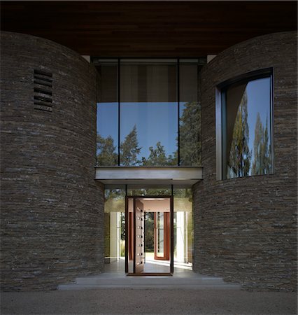 simsearch:845-03777225,k - Ad Astra. Entrance with curved stone walls and glass front door. Architects: Munkenbeck and Marshall Stock Photo - Rights-Managed, Code: 845-03777225