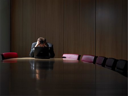 stressed looking people - Office life and interiors. Businessman in boardroom using laptop with hands on head in despair. Stock Photo - Rights-Managed, Code: 845-03777242