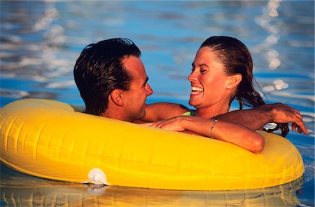 1980s YOUNG COUPLE IN INNER TUBE IN THE POOL Stock Photo - Rights-Managed, Code: 846-05645744