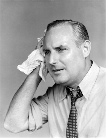 1940s OVERHEATED MAN WITH OPEN SHIRT AND TIE HOLDING A HANDKERCHIEF TO HIS TEMPLE Stock Photo - Rights-Managed, Code: 846-05645848