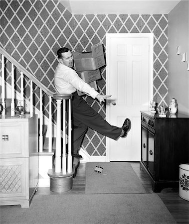simsearch:877-06835852,k - 1950s MAN CARRYING STORAGE BOXES DOWN STAIRS TRIPPING AND FALLING ON TOY ON FLOOR Stock Photo - Rights-Managed, Code: 846-05645860