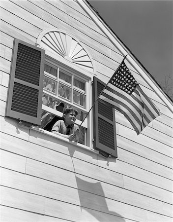 simsearch:846-03164576,k - 1930s - 1940s SMILING BOY LEANING OUT OF UPSTAIRS WINDOW HOLDING AMERICAN FLAG Stock Photo - Rights-Managed, Code: 846-05645957