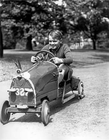 simsearch:846-05646554,k - 1930s BOY DRIVING HOME BUILT RACE CAR HOLDING STEERING WHEEL Stock Photo - Rights-Managed, Code: 846-05645968