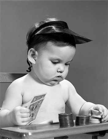 1960s BABY GIRL PLAYING WITH CARDS POKER CHIPS GAMBLER INDOOR Stock Photo - Rights-Managed, Code: 846-05646024