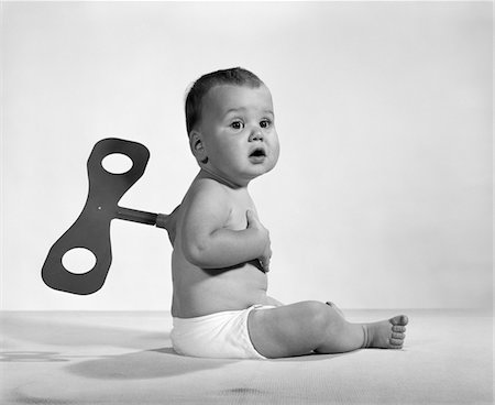 1960s - 1970s SEATED BABY IN DIAPER WITH WINDUP KEY IN HIS BACK Stock Photo - Rights-Managed, Code: 846-05646053