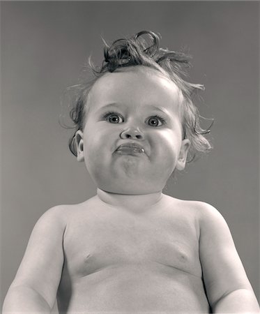 serious face - 1950s PORTRAIT BABY WITH MESSY HAIR & PURSED LIPS Stock Photo - Rights-Managed, Code: 846-05646126