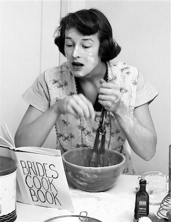 simsearch:846-02793227,k - 1950s WOMAN FACE COVERED FLOUR MIXING INGREDIENTS READING BRIDES COOK BOOK Stock Photo - Rights-Managed, Code: 846-05646159