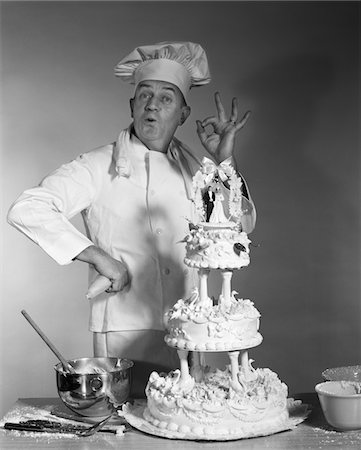 simsearch:846-08226158,k - 1950s - 1960s - 1970s MAN PORTRAIT BAKER MAKING OK SUCCESS HAND SIGN NEXT TO THREE TIER WEDDING CAKE BRIDE AND GROOM ON TOP Stock Photo - Rights-Managed, Code: 846-05646231