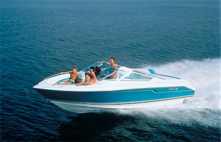1990s FAMILY IN MOTOR BOAT SPEEDING OVER WATER MOTHER FATHER 2 KIDS Stock Photo - Rights-Managed, Code: 846-05646244