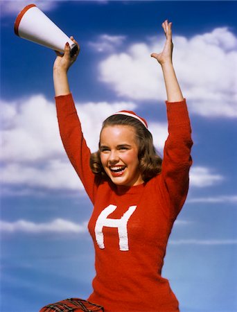 school sports - 1940s - 1950s TEENAGE GIRL CHEERLEADER RED SWEATER WITH her ARMS IN AIR HOLDING MEGAPHONE Stock Photo - Rights-Managed, Code: 846-05646251