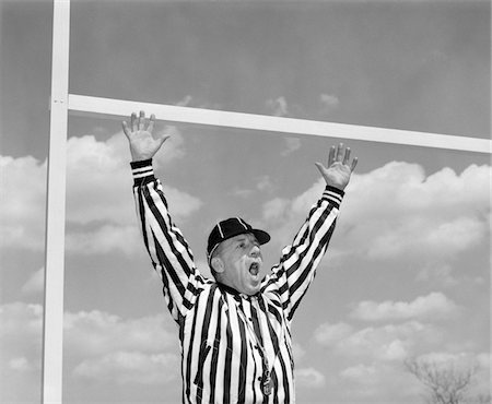 simsearch:846-06111784,k - 1960s AMERICAN FOOTBALL REFEREE MAKING TOUCHDOWN HAND SIGNAL AT GOAL POST Stock Photo - Rights-Managed, Code: 846-05646321