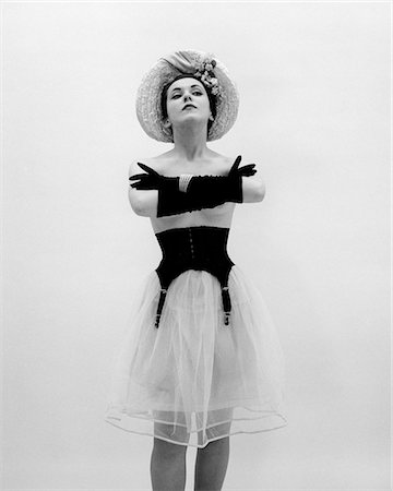 female fashion figures - 1950s WOMAN TOPLESS WEARING STRAW HAT LONG GLOVES BLACK GARTER BELT ARMS FOLDED IN FRONT Stock Photo - Rights-Managed, Code: 846-05646365