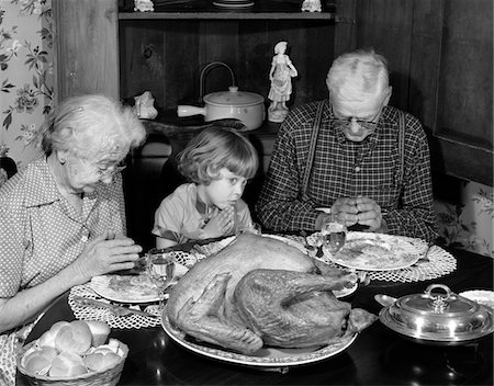 simsearch:846-02793526,k - 1950s - 1960s LITTLE GIRL LOOK AT TURKEY SITTING BETWEEN GRANDMOTHER GRANDFATHER SAYING GRACE AT TABLE Stock Photo - Rights-Managed, Code: 846-05646361