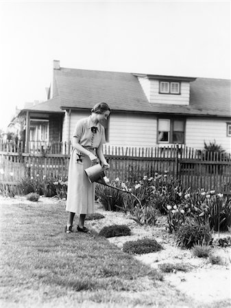 flowers vintage - 1930s WOMAN WATERING GARDEN  WITH WATER CAN Stock Photo - Rights-Managed, Code: 846-05646378