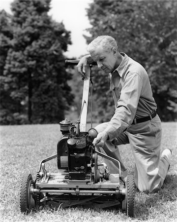 1940s ELDERLY MAN IN YARD KNEELING DOWN TO FIX LAWNMOWER Stock Photo - Rights-Managed, Code: 846-05646431