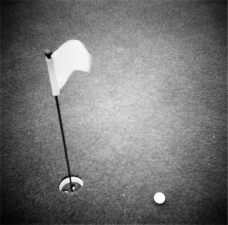 2000s GOLF BALL ON PUTTING GREEN WITH FLAG MARKER IN HOLE FROM ABOVE Stock Photo - Rights-Managed, Code: 846-05646432