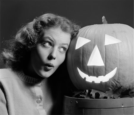 pumpkin carving - 1940s TEEN GIRL LOOK SCARED HEAD TO HEAD WITH CARVED PUMPKIN JACK-O-LANTERN Stock Photo - Rights-Managed, Code: 846-05646445