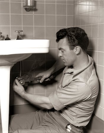 1950s MAN PLUMBER FIXING BATHROOM SINK Stock Photo - Rights-Managed, Code: 846-05646467