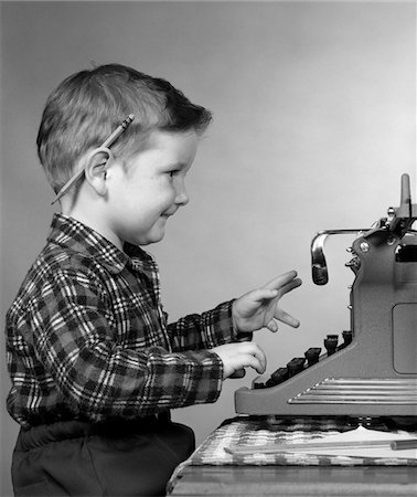1950s SMILING YOUNG BOY TYPING ON TYPEWRITER Stock Photo - Rights-Managed, Code: 846-05646560