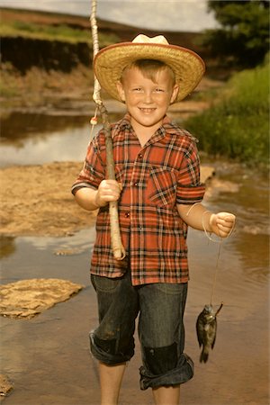 pole - 1950s SMILING BOY STRAW HAT HOLDING FISHING POLE WEARING PLAID SHIRT BLUE JEANS Stock Photo - Rights-Managed, Code: 846-05646631