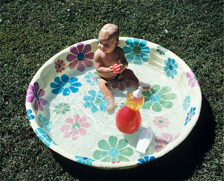 plastic toys - 1970s BABY SITTING IN PLASTIC BACKYARD KIDDY POOL VIEWED FROM ABOVE Stock Photo - Rights-Managed, Code: 846-05646712