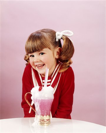 retro fun - 1960s - 19670s HAPPY LITTLE GIRL WITH ICE CREAM SODA STUDIO PONYTAIL Stock Photo - Rights-Managed, Code: 846-05646939