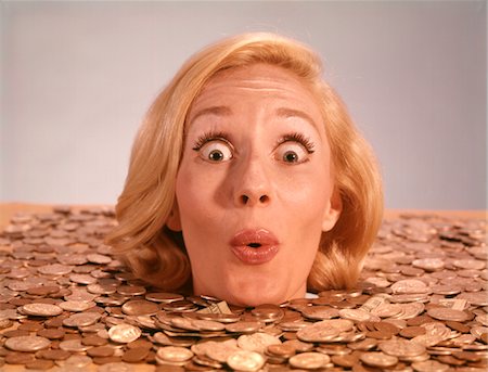 1960s SILLY WACKY EXPRESSION ON FUNNY WOMAN UP TO NECK IN COINS AND CURRENCY DROWNING IN LUCK Foto de stock - Con derechos protegidos, Código: 846-05646955