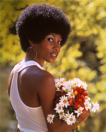 sexy, african american, female - 1970s SMILING AFRICAN-AMERICAN WOMAN WEARING HOOP EARRINGS WHITE TANK TOP HOLDING A BOUQUET SPRING FLOWERS Stock Photo - Rights-Managed, Code: 846-05646991