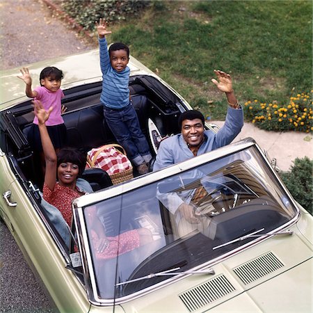simsearch:846-02795537,k - 1970s AFRICAN-AMERICAN FAMILY FATHER MOTHER SON DAUGHTER WAVING FROM CONVERTIBLE CAR OUTDOOR Stock Photo - Rights-Managed, Code: 846-05647217